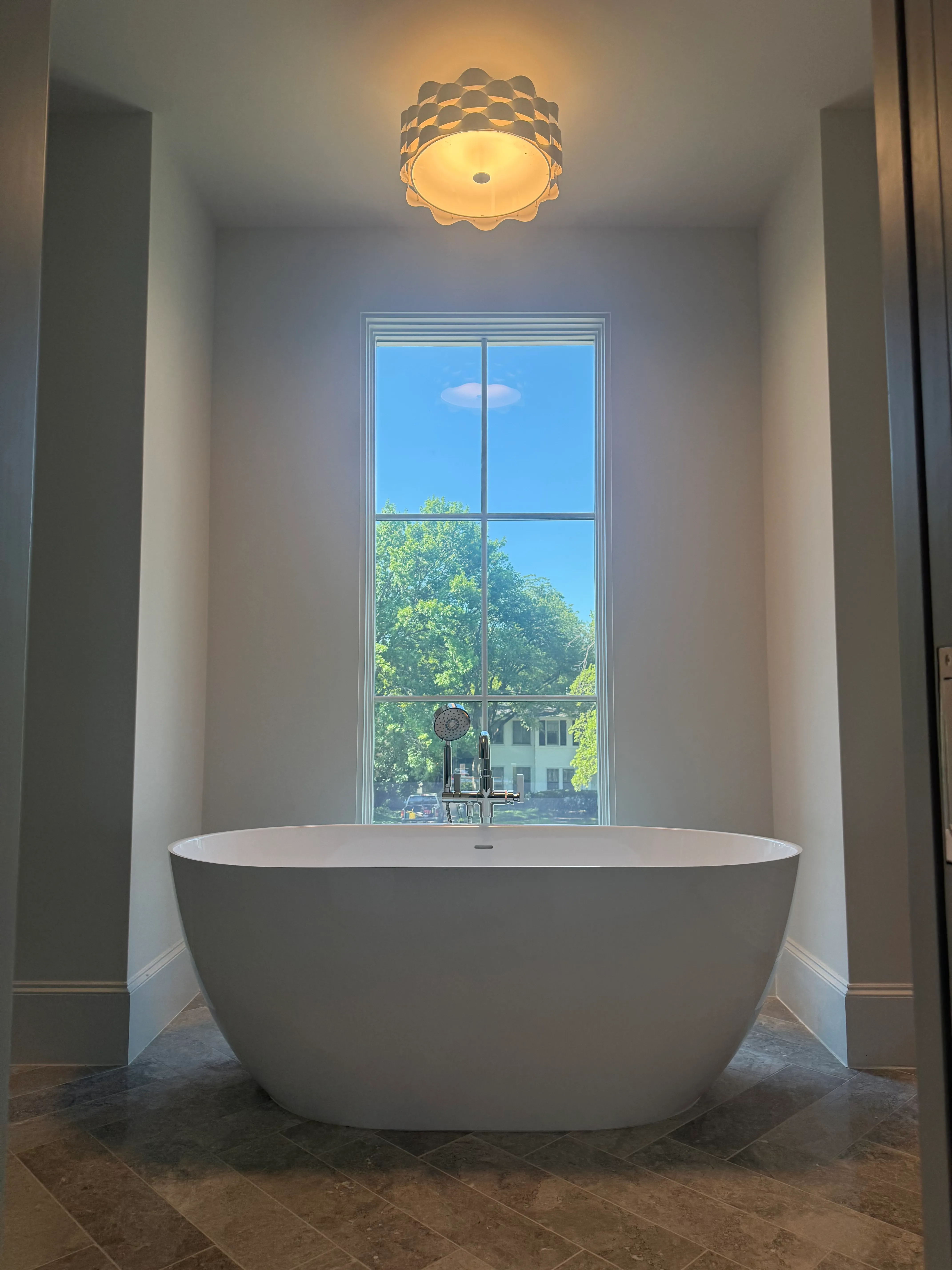 Soaking tub in a window alcove with the glass clear