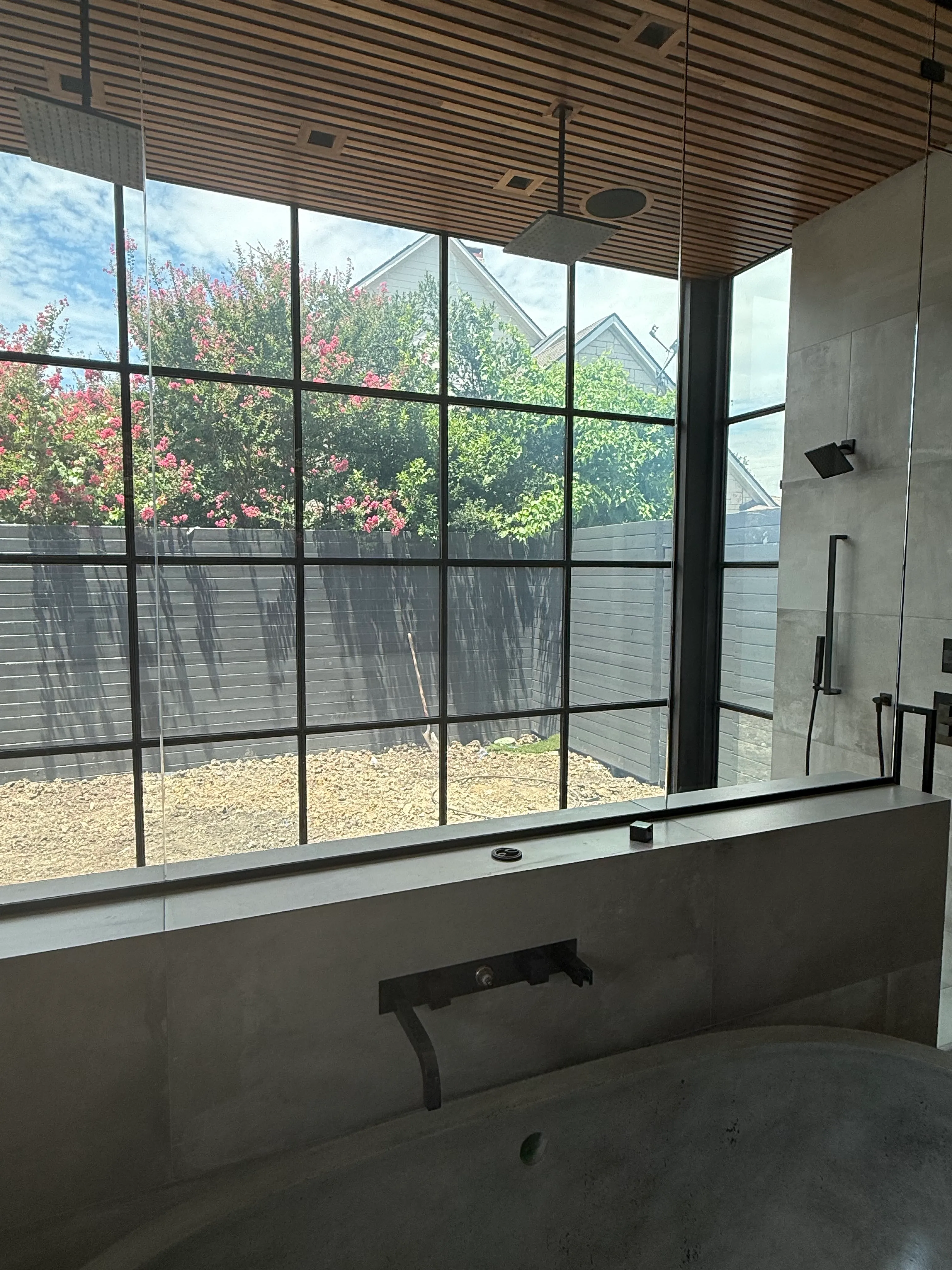 Revive floor-to-ceiling shower window in its clear state