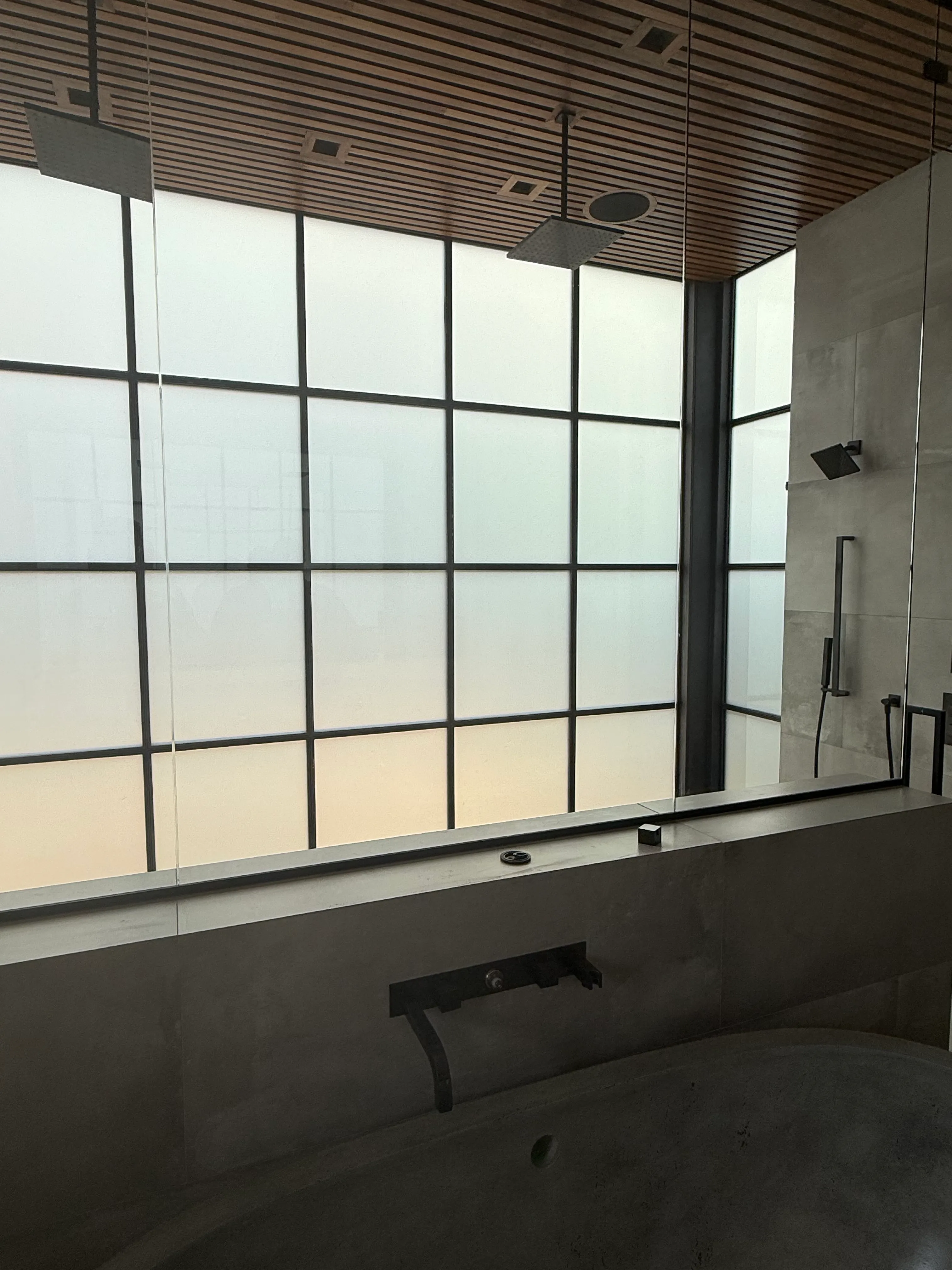 The same floor-to-ceiling shower window switched to frosted for privacy